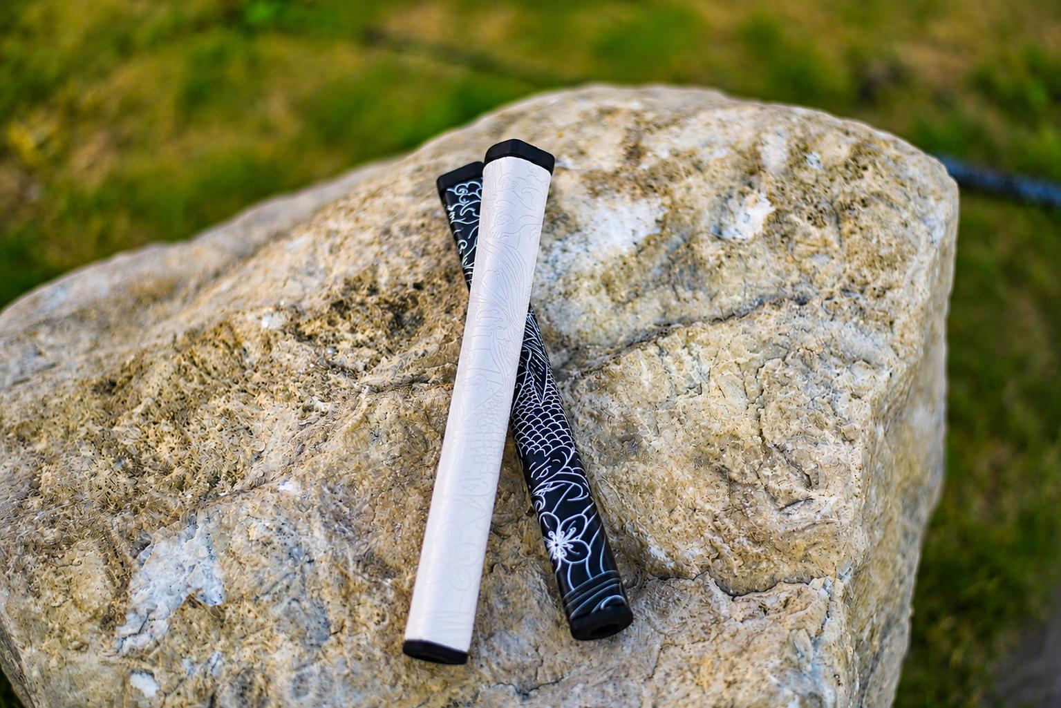 Pearl and Jewel Kaiyen putter grips resting on a stone